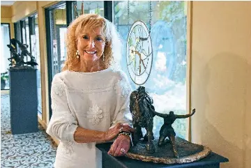 Charlotte Bailey Rierson standing beside a sculpture