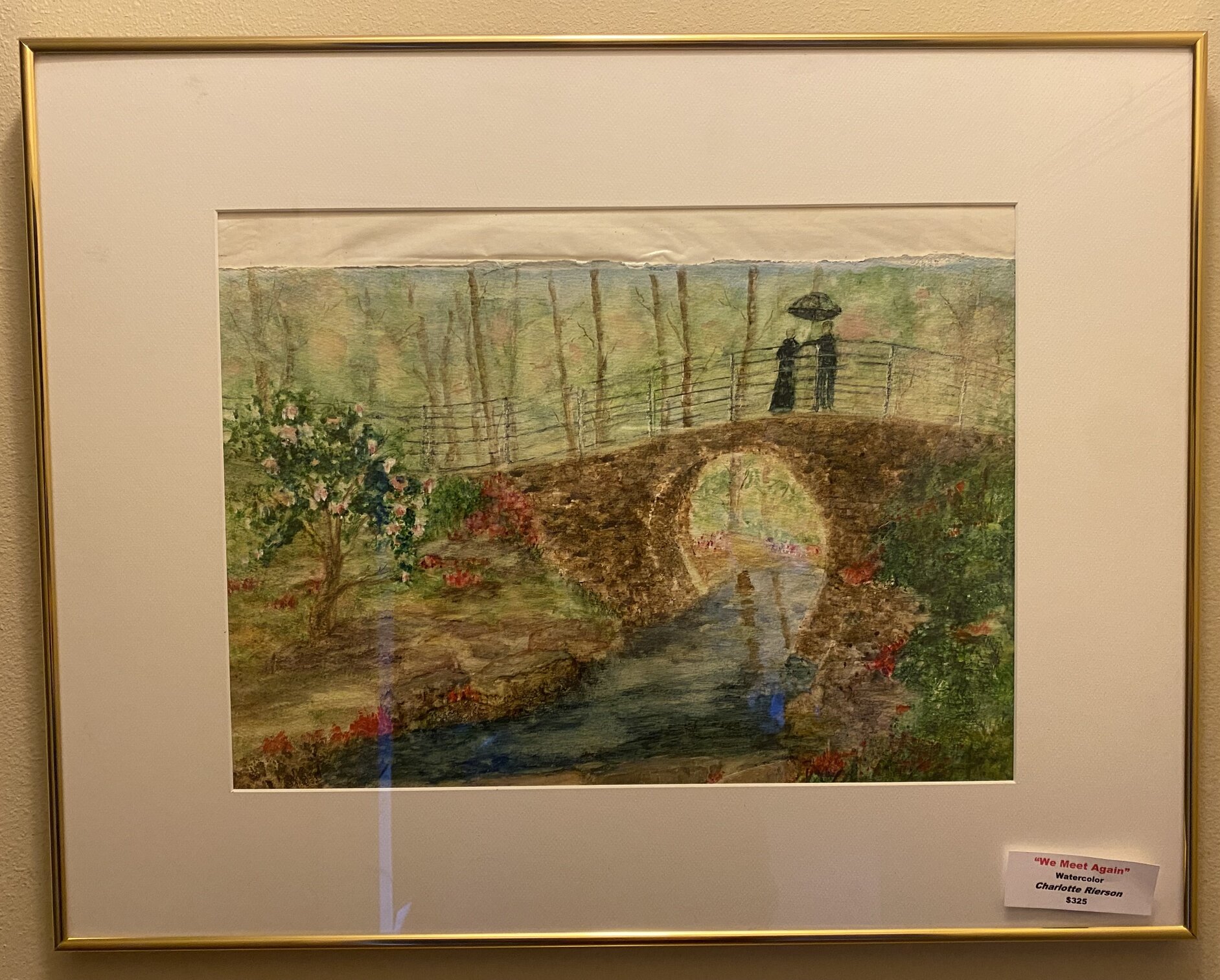 Watercolor of two figures with an umbrella standing on a stone bridge titled We Meet Again